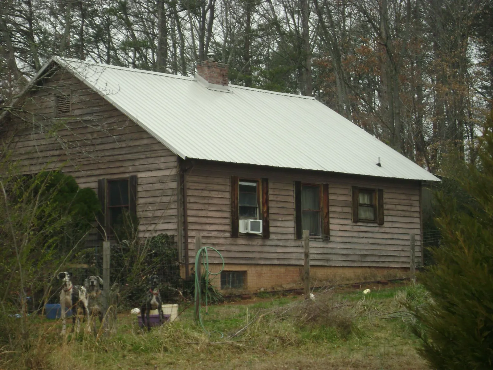 White metal roof on an old wood sided farmhouse, from a Metal Roof Installation job in Center Ossipee